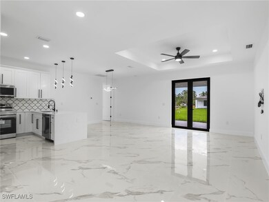 Unfurnished living room featuring a tray ceiling,