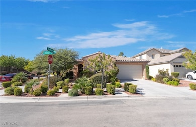Mediterranean / spanish home featuring concrete driveway, a tiled roof, a garage, and stucco siding