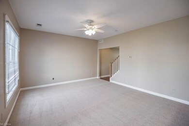 Living room with light carpet and ceiling fan