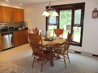 Large eat in area in kitchen with bay window.