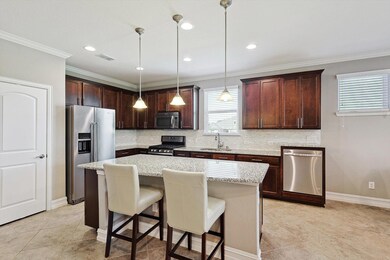 Kitchen featuring tasteful backsplash, crown moldi