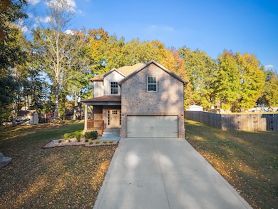 Extra long concrete driveway sits the home back off the road