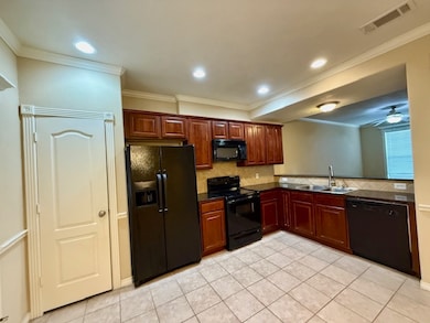 Kitchen with backsplash, ornamental molding, black appliances, recessed lighting, and light tile patterned floors