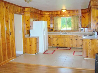 Kitchen has tile floors, side by side refrigerator, stove and dishwasher.