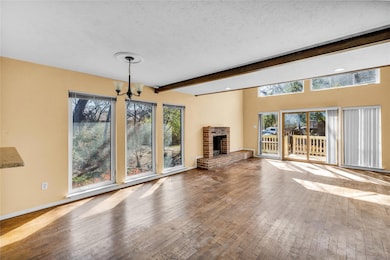Unfurnished living room with an inviting chandelie