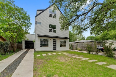 Back of property with fence and a yard