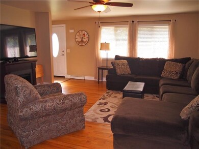 Foyer leads to this large living room with hardwoo