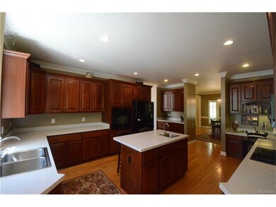 kitchen offers center island, recessed lights, wal