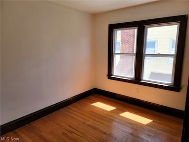 Unfurnished room with hardwood / wood-style flooring