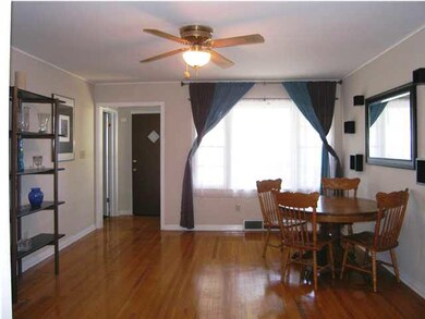The spacious living room with beautiful hardwood f