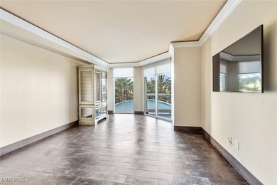 Empty room featuring ornamental molding, baseboards, and dark wood-style flooring