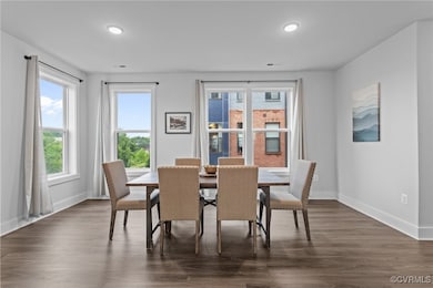 Dining space featuring baseboards, dark wood-style
