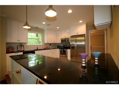 The kitchen has a central location, nice and open 