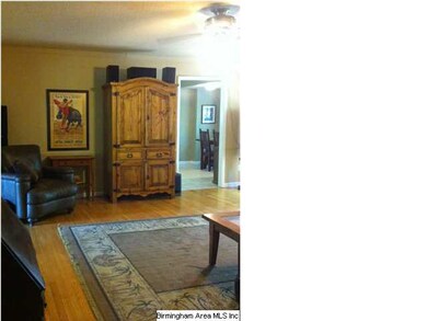 Large den is complete with hardwood floors, firepl