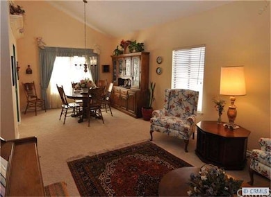 Dining room with vaulted ceilings and chandelier