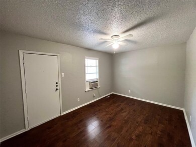 Spare room featuring hardwood / wood-style flooring, ceiling fan, and a textured ceiling