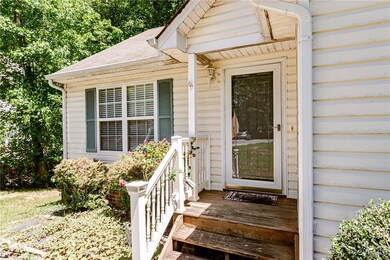 View of exterior entry with a shingled roof