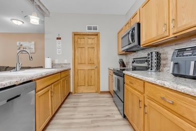 Kitchen with utility and laundry room next door