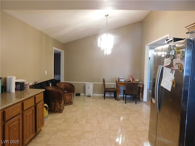 Dining room with a chandelier and light tile patte