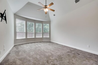 Large Primary bedroom with Bay windows for beautiful seating with a view and large amount of sunlight, high vaulted ceiling, ceiling fan, and carpet flooring
