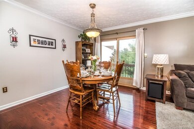 Dining area with glistening hardwood floor leads o