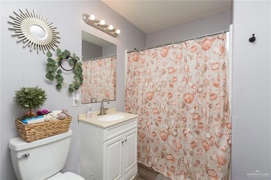 Bathroom featuring toilet, walk in shower, hardwood / wood-style flooring, and vanity