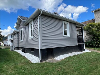 View of side of property featuring central air con