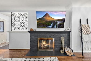 Detailed view of wood finished floors and a fireplace