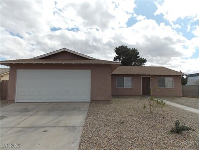Ranch-style house featuring stucco siding, an atta