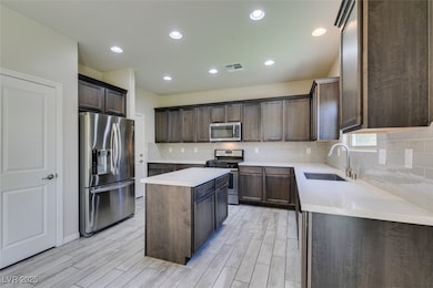 Kitchen with stainless steel appliances, dark brow