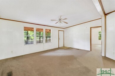 Living room view from hallway. Open door to the ri