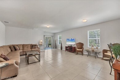 Living room with light tile patterned floors, visi