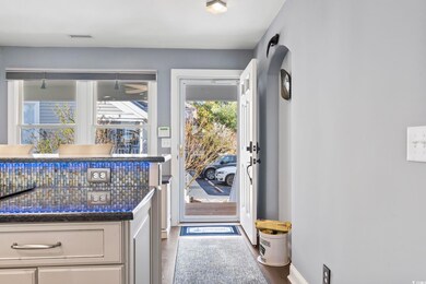 Doorway to outside with hardwood / wood-style floo