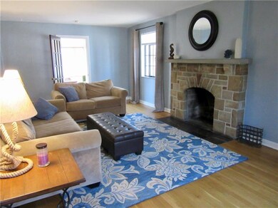Spacious, bright living room with a stone fireplac