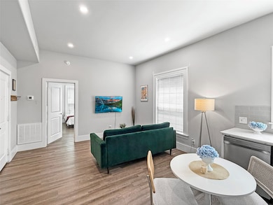 Living area with wood finished floors and recessed lighting