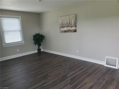 Spacious living space with lots of natural light from the new windows
