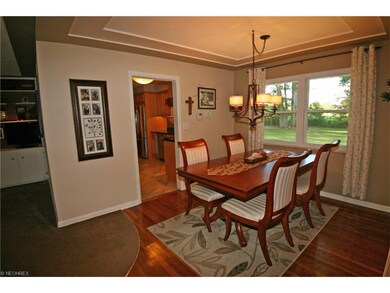 Dining room with hardwood floor is open from the l
