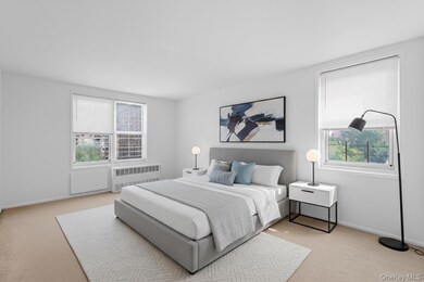 Bedroom with light carpet and radiator