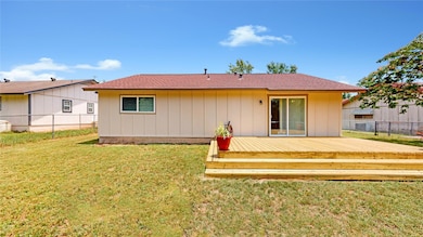 Back of house featuring a wooden deck