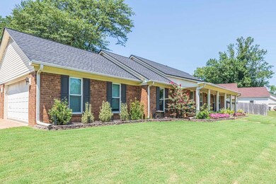 Single story home featuring a front lawn and a gar
