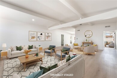 Living room featuring beam ceiling, wood finished