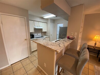 This cozy kitchen features granite countertops wit