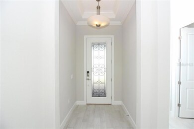 What a warm and inviting foyer entrance with a grand front door.