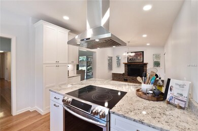 The large cooking island (with breakfast bar space) in the kitchen looks out into the dining room
