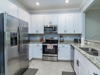 Kitchen featuring white cabinetry, ornamental mold