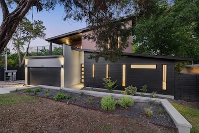Contemporary house featuring a balcony, an attach