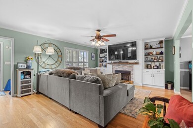 Living room featuring a fireplace, light hardwood 