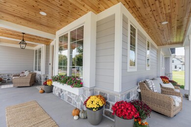 Create memories on this wrap around front porch with stone detail, cedar ceiling, stone accent and more!