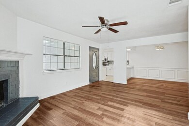 Unfurnished living room featuring ceiling fan, a f