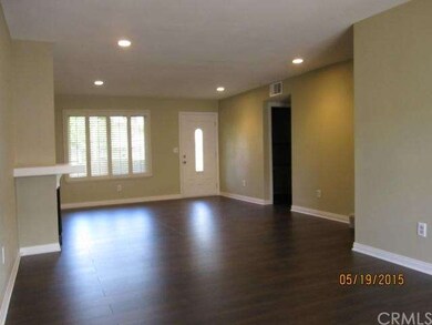 View of Living Room from Dining area; staircase to